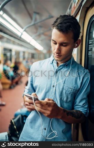 Phone addict man using gadget in metro, addiction problem, social addicted people, modern lifestyle
