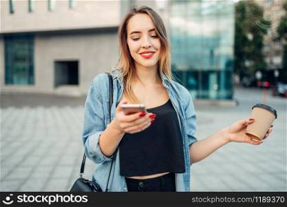 Phone addiction, addict woman holds gadget and coffee in hands, social addicted people