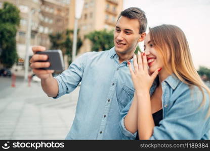 Phone addiction, couple looking on smartphone screen, social addicted people, modern lifestyle