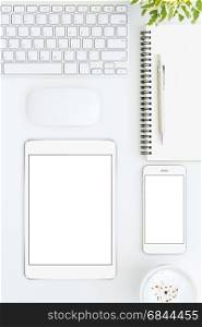 phone and tablet blank screen on white table format vertical top view. phone and tablet blank screen on white table format vertical top