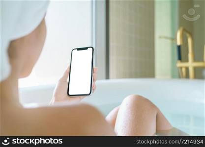 phone blank screen display in woman hand, relax in bathtub with smartphone in morning time