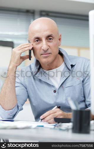 phoning man looking at camera