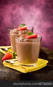 phot of delicious chocolate mousse with strawberries and yellow napkins