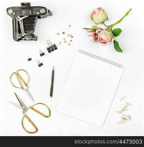 Photo album, flowers, vintage camera, scissors on white background