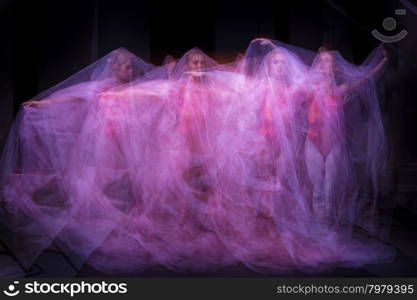 photo as art - a sensual and emotional dance of beautiful ballerina through the veil . photo as art - a sensual and emotional dance of beautiful ballerina through the veil on a dark background. A stroboscopic image of the one model