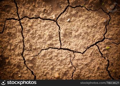 Photo cracked earth in a dry terrain. The land is cracked due the lack of water.