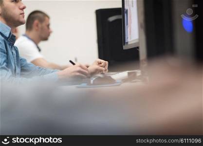 photo editors working with graphic tablet and pen on photographs in retouching studio