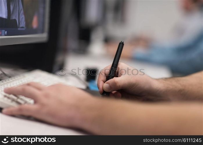 photo editors working with graphic tablet and pen on photographs in retouching studio