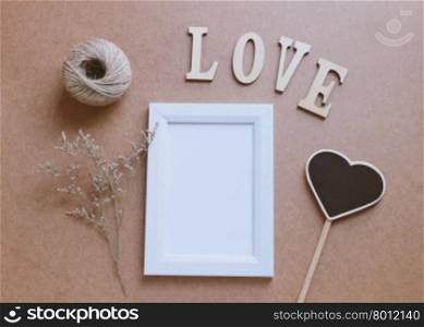 Photo frame mockup and craft decorated with love wooden alphabet