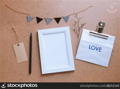 Photo frame mockup and cute craft decorated with paper bag gift