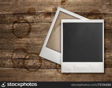 Photo frames over rustic wooden background