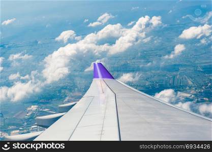 photo from the window of an airplane flying over Thailand, view of the wing