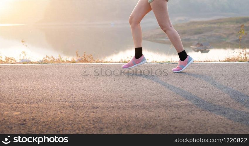 Photo front view Sporty Asia young woman wear sports shoes running on asphalt road, Fitness and workout wellness, Healthy lifestyle concept