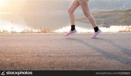 Photo front view Sporty Asia young woman wear sports shoes running on asphalt road, Fitness and workout wellness, Healthy lifestyle concept