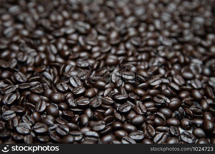 photo macro close up texture of roasted coffee beans dark, can be used as a background.