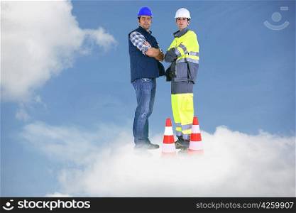 Photo-montage of building workers standing on a cloud