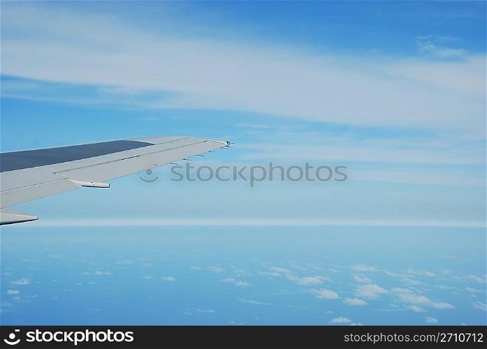 photo of a airplane wing and clouscape scene