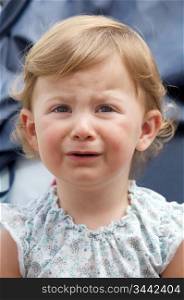Photo of a beautiful baby caucasian girl crying