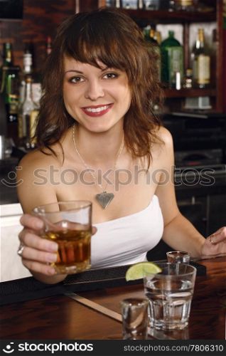 Photo of a beautiful bartender serving you a glass of whisky.