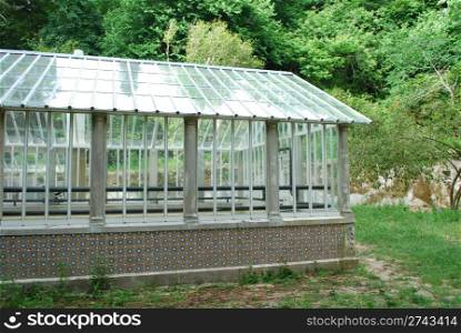 photo of a beautiful greenhouse on a jungle scenery