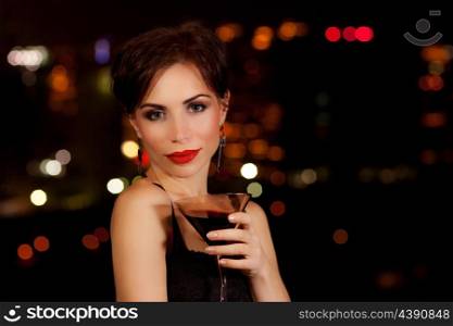 Photo of a beautiful woman having martini in outdoor restaurant, celebration party, city nightlife lifestyle, glamorous lady with drink, female enjoying cocktail
