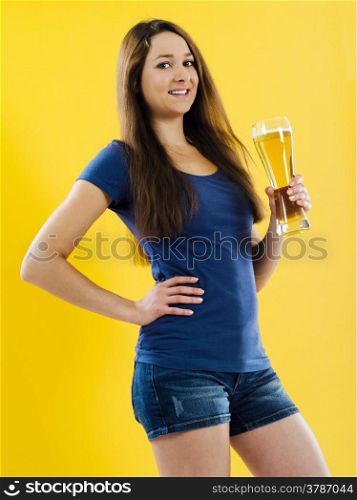 Photo of a beautiful young brunette woman drinking beer from a tall glass.&#xA;