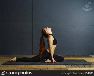 Photo of a beautiful young woman doing yoga stretches.