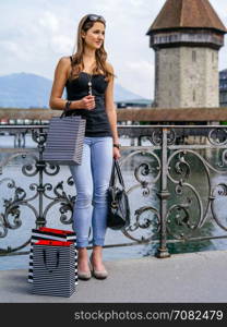 Photo of a beautiful young woman standing with shopping bags, in Luzern Switzerland.&#xA;