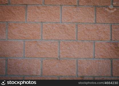 Photo of a building blocks forming a red wall