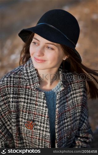 Photo of a carefree girl strolling against the background of trees in early spring.. A young woman on a spring walk 3516.