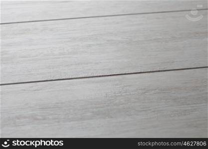 Photo of a close up of a gray wooden floor. Dry laminated