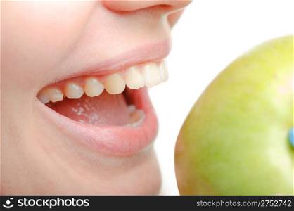 Photo of a female mouth and green apple close up