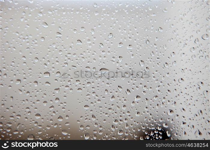 Photo of a glass full of water drops from rain