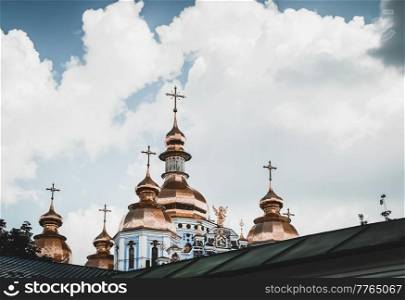 Photo of a Great Beautiful St. Michael&rsquo;s Cathedral with its Famous Golden Domes over White Fluffy Clouds. Ukrainian Orthodox Church in Kyiv.. St. Michael&rsquo;s Cathedral