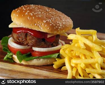 Photo of a hamburger and french fries on a wooden board.&#xA;