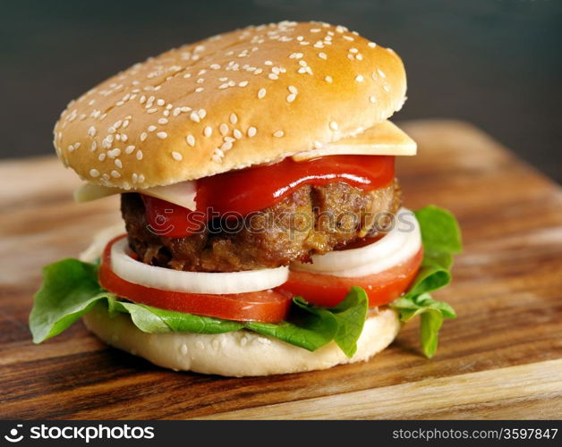 Photo of a hamburger on a wooden board.