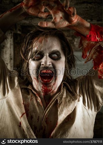 Photo of a hungry zombie covered with blood about to attack you.