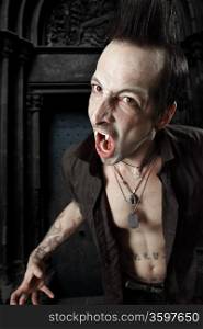 Photo of a male vampire with mouth open and fangs showing. Harsh lighting and heavily filtered for scarier feel.