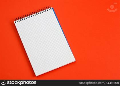 photo of a notebook over a red background