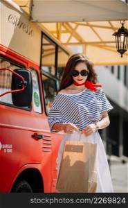 Photo of a perky beauty on the background of a red food truck with coffee.. A perky beautys walk through the summer streets of Arzamas 4188.