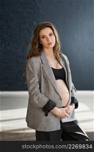 Photo of a pregnant girl in a photo studio.. A pregnant girl with a bare big belly 4114.