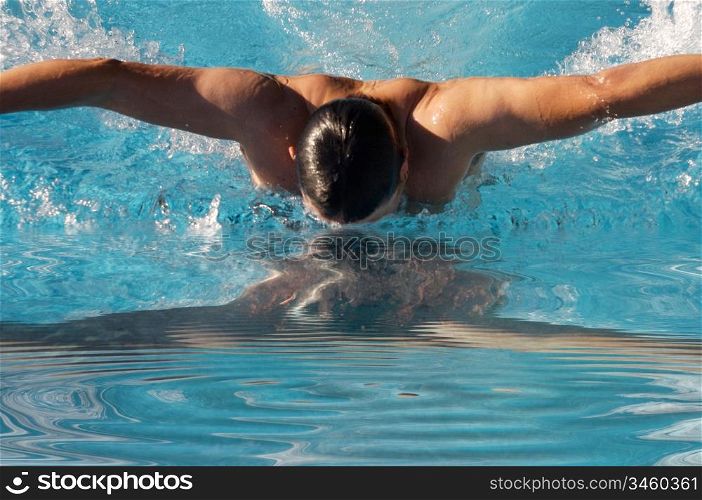 photo of a swimmer doing spring in swimming pool