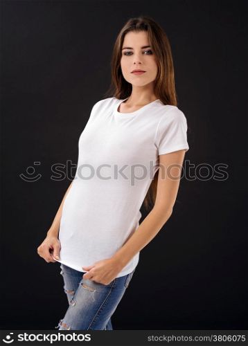 Photo of a young beautiful sexy female with blank white shirt, front and back, over black background. Ready for your design or artwork.