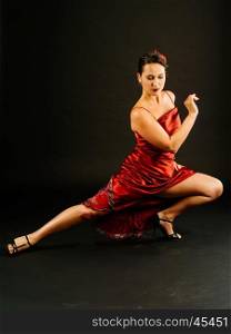 Photo of a young beautiful woman performing tango moves.