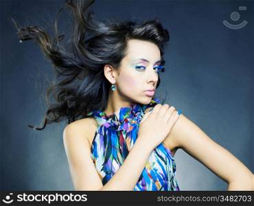Photo of a young beautiful woman with bright makeup and manicure