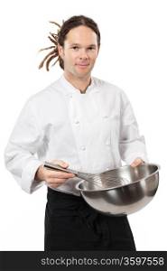 Photo of a young chef with dreadlocks holding a large mixing bowl and mixing with a whisk.