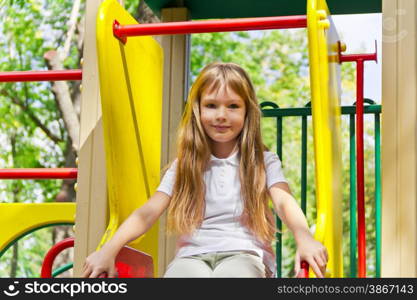 Photo of active girl on nursery platform in summer