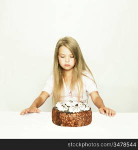 Photo of adorable little girl with cake on white background