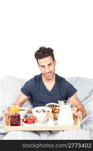photo of adult man having breakfast in the bed on white background