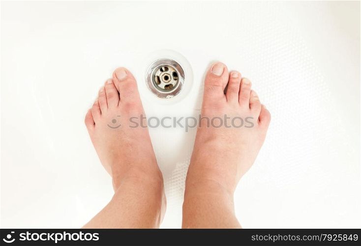 Photo of adult men feet at shower sink